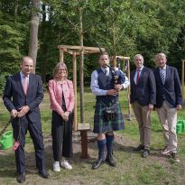 Feierliche Pflanzung der Stileiche. Links vom Dudelsack-Spieler der britische Honorarkonsul Christoph Enge und die britische Botschafterin Jill Gallard. Zu seiner Rechten: Tim Großmann, Direktor des Bürgerparks und Johann-Diedrich Bruns vom Bund deutscher Baumschulen e.V.